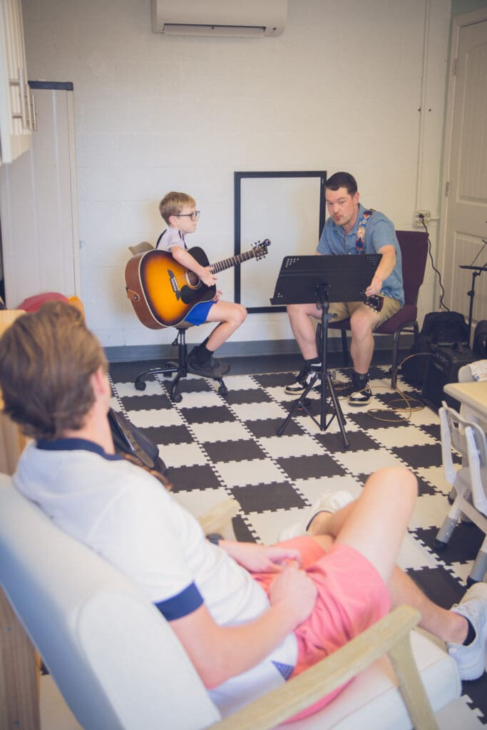 Young student playing the guitar