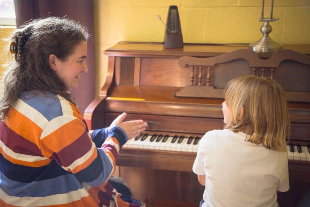 Young student playing piano during a lesson