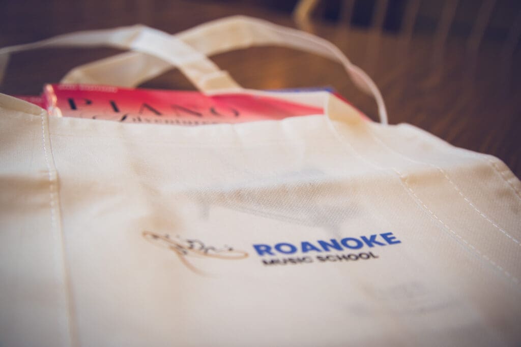 Piano lesson books in a Roanoke Music School bag